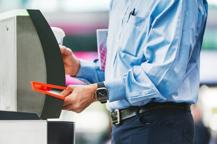 A person scanning a ticket at an entry gate.